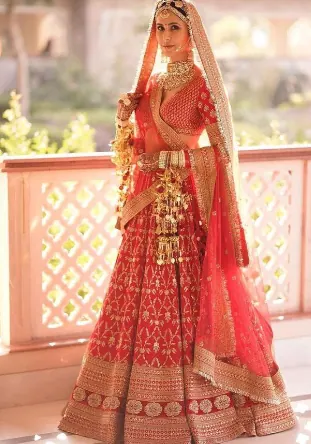 A person in a red dress
Description automatically generated